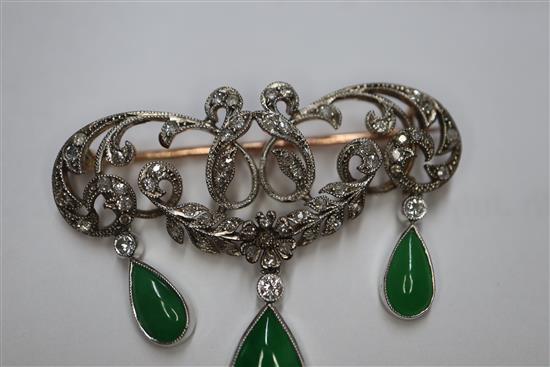 A 1920s yellow metal, diamond and jadeite set drop openwork scroll brooch, width 38mm.
